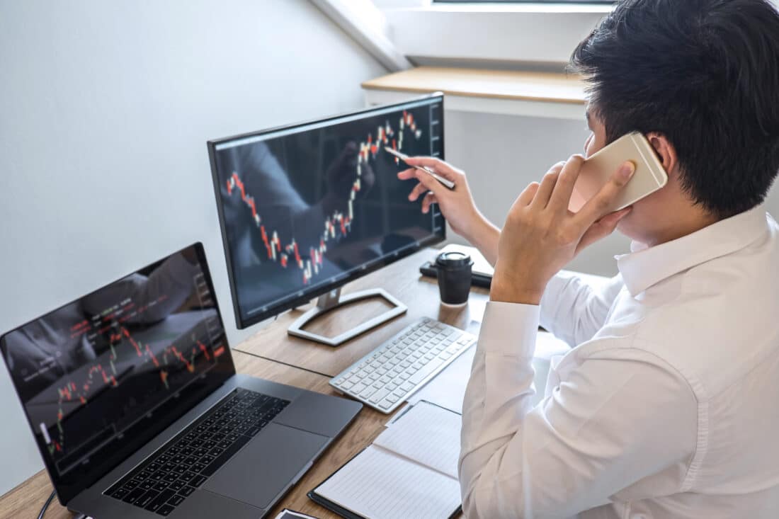 A man on his computer looking at stocks.