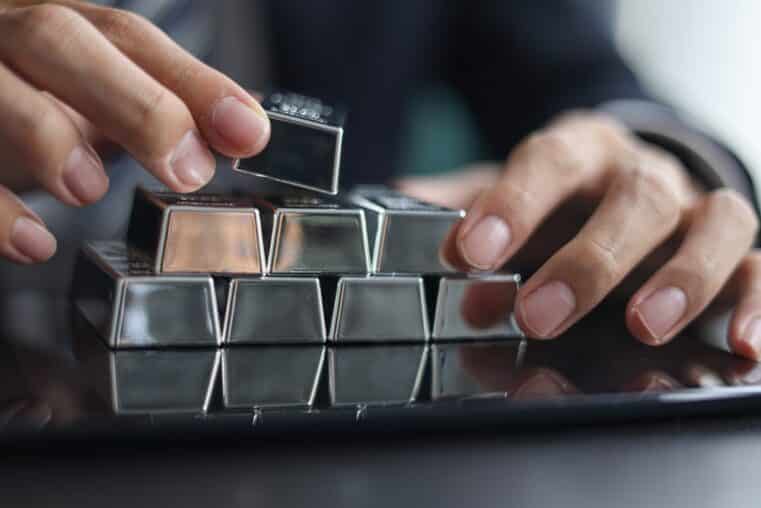 COMEX Silver Forecast concept showing silver bars, futures market data, and physical silver demand trends
