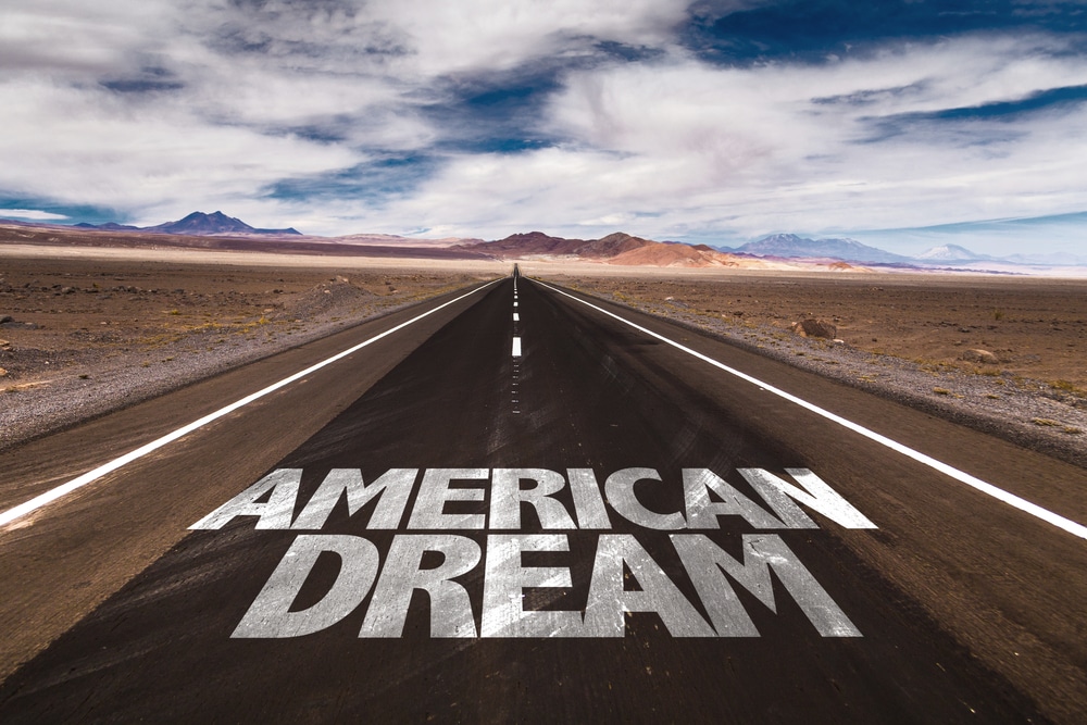 American Dream text painted on an empty highway symbolizing collapsing consumer confidence and economic uncertainty in America