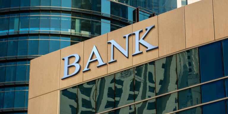 Bank,Sign,On,Glass,Wall,Of,Business,Center