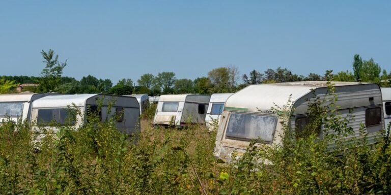 Panorama,Abandoned,Campsite,With,Old,Caravans