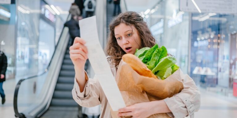 A,Woman,In,Shock,Looks,Into,A,Paper,Check,From