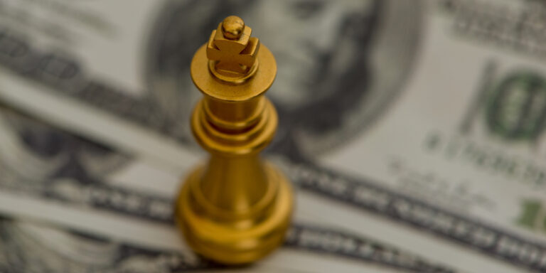 Figure,Of,The,King,On,A,Pile,Of,Dollar,Bills