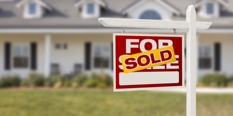 Red,Sold,For,Sale,Real,Estate,Sign,In,Front,Of