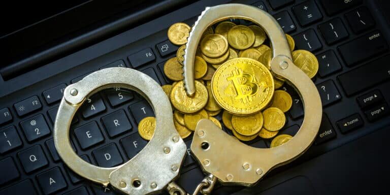 Golden,Bitcoins,(cryptocurrency),With,Handcuffs,On,Computer,Keyboard.