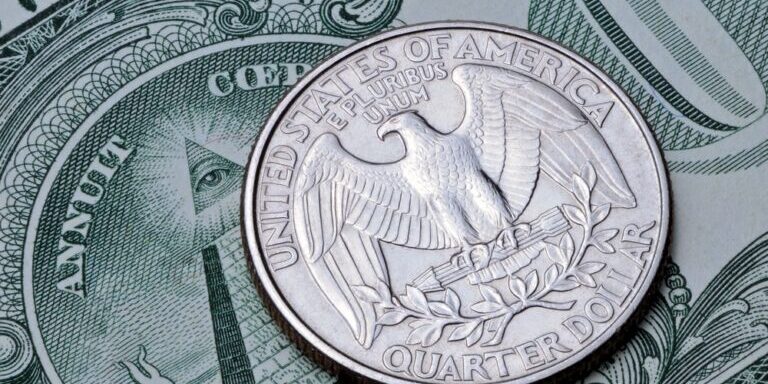US coin quarter dollar on one dollar bill.