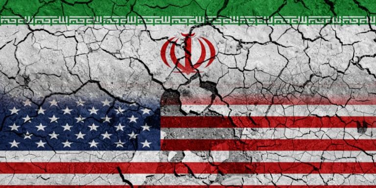 Flag,Of,Usa,And,Iran,On,Cracked,Concrete,Wall,Background.