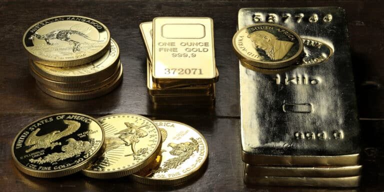 Gold,Ingots,An,Various,Bullion,Coins,On,Wooden,Background