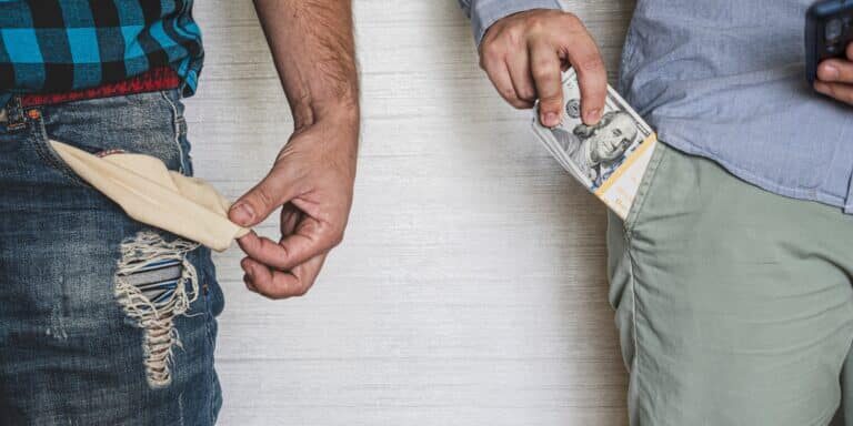 A,Businessman,With,Money,In,His,Pocket,And,A,Poor