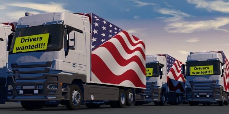 Trucks,With,A,Drivers,Wanted,Sign,-,Truck,Drivers,Shortage