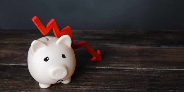 Sad,Piggy,Bank,And,Down,Arrow.,Savings,And,Reserves,Decrease.