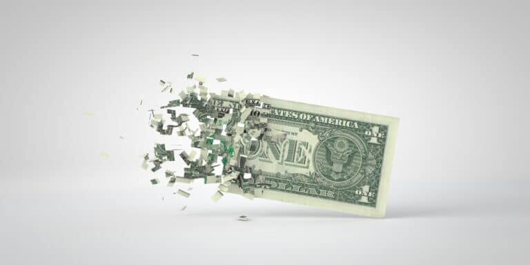 One,Dollar,Bill,Breaking,Into,Pieces.,Inflation,And,Recession,Concept.