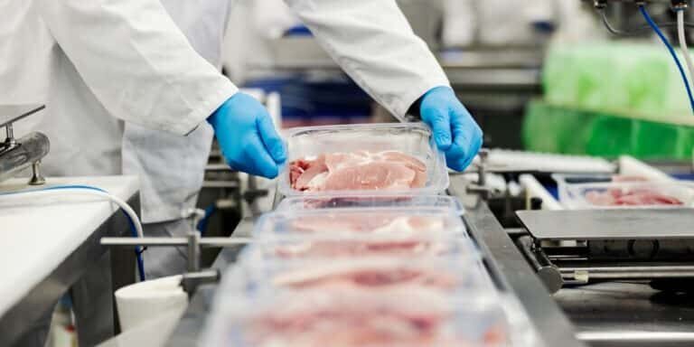 Close,Up,Of,A,Meat,Industry,Worker,Gathering,Packed,Meat
