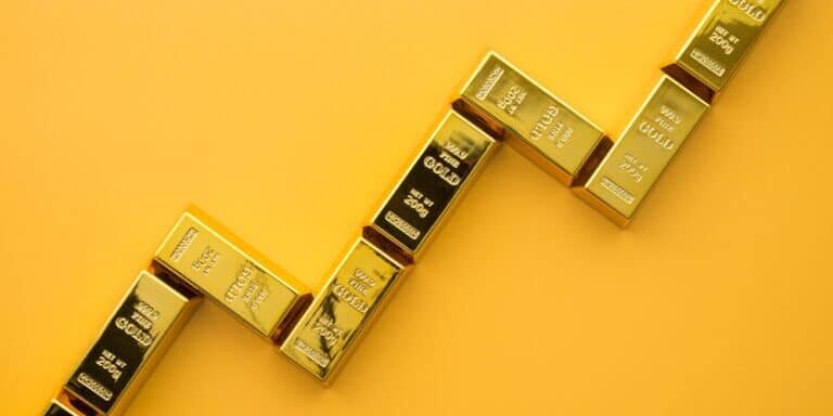 Gold,Bars,As,Graph,Chart,Growing,Up,On,Yellow,Background