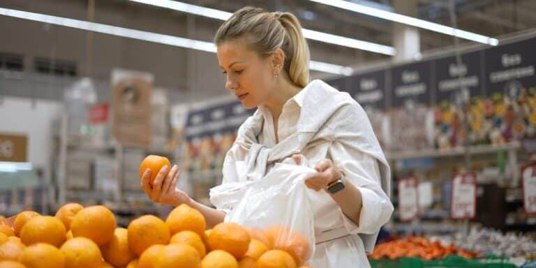 Woman,Buy,Healthy,Food,Fruit,Market.,Customer,Take,Ripe,Orange