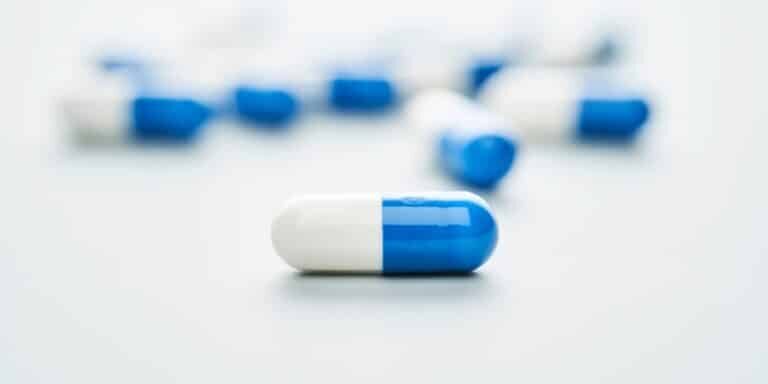 Blue,And,White,Capsules,On,A,Blue,Background.