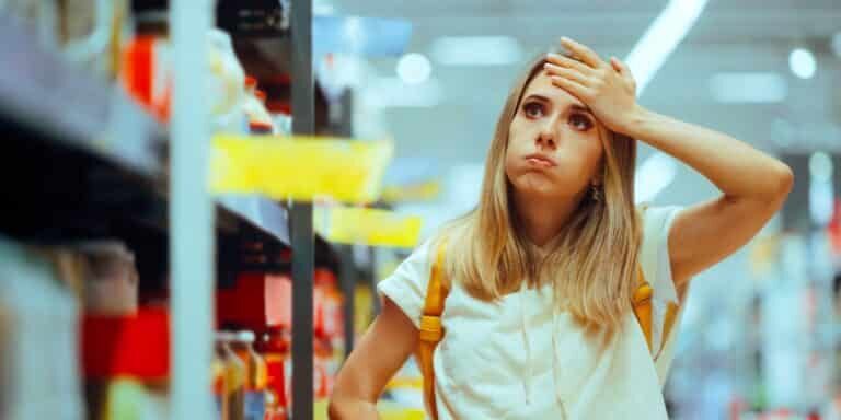 Stressed,Woman,Checking,Inflated,Prices,In,A,Supermarket.,Unhappy,Hypermarket