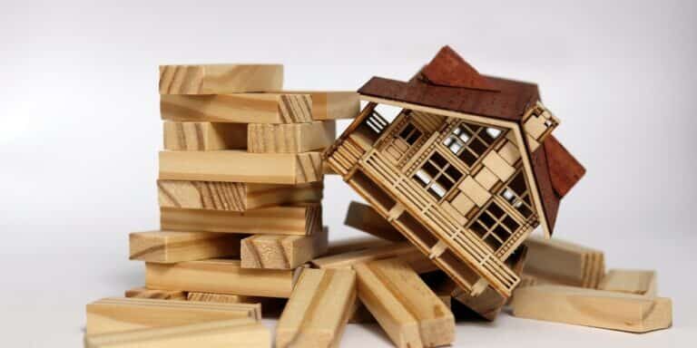 Crisis,In,The,Real,Estate,Market.,Wooden,Houses,Sit,Among Crisis,In,The,Real,Estate,Market.,Wooden,Houses,Sit,Among