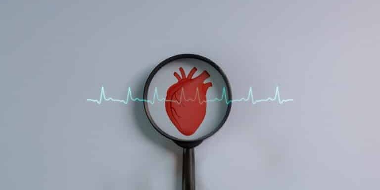 Magnifying,Glass,Focuses,The,Heartbeat,Icon,On,A,Blue,Background