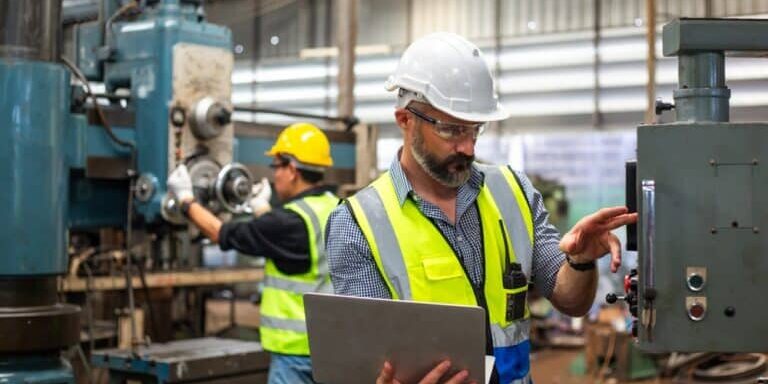 Industrial,Man,Engineer,Wear,Uniform,And,Helmet,Using,Laptop,Are