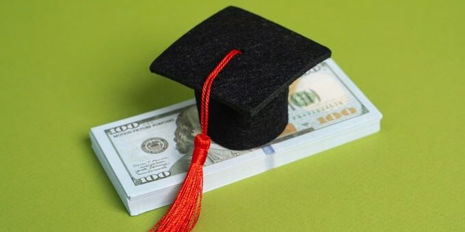 A,Stack,Of,Money,And,A,Graduation,Cap.,Concept,Of