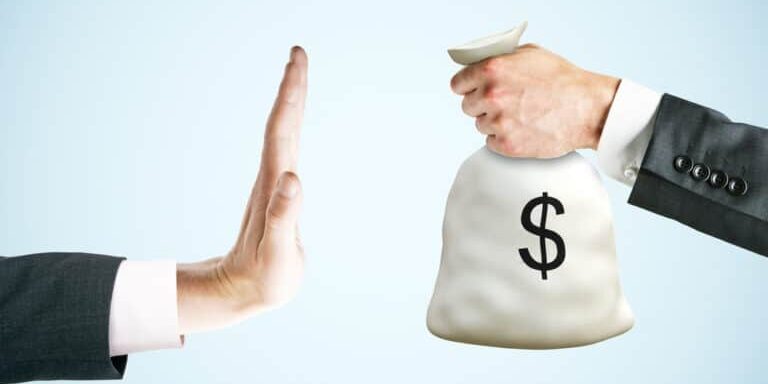 Hand,Saying,No,To,Money,Bag,On,Light,Background.,Stop Hand,Saying,No,To,Money,Bag,On,Light,Background.,Stop