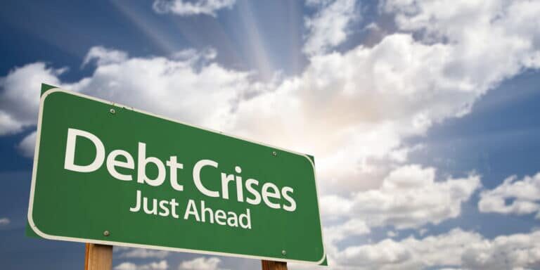 Debt,Crises,Green,Road,Sign,Against,Dramatic,Sky,,Clouds,And