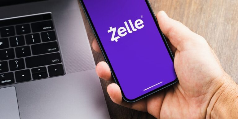 Male,Hand,Holding,A,Smartphone,With,Zelle,App,On,The